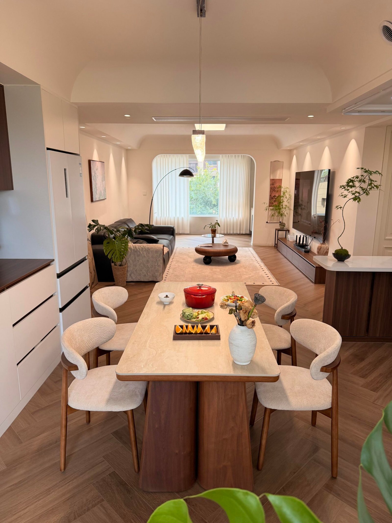 Elegant Dining Table Set for 4 beside a walnut kitchen with sheer curtains.