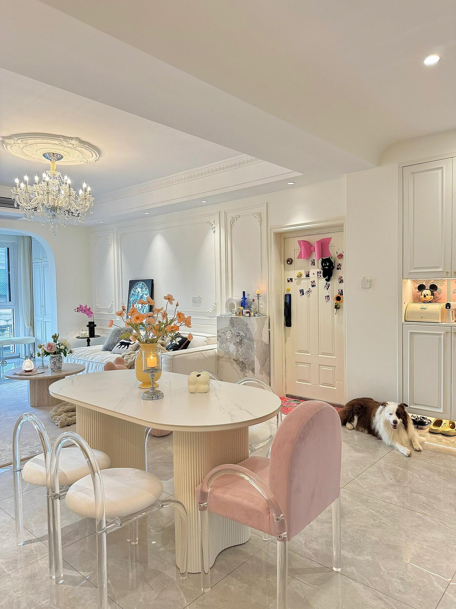 Spacious dining area with a rectangular table and elegant upholstered seating