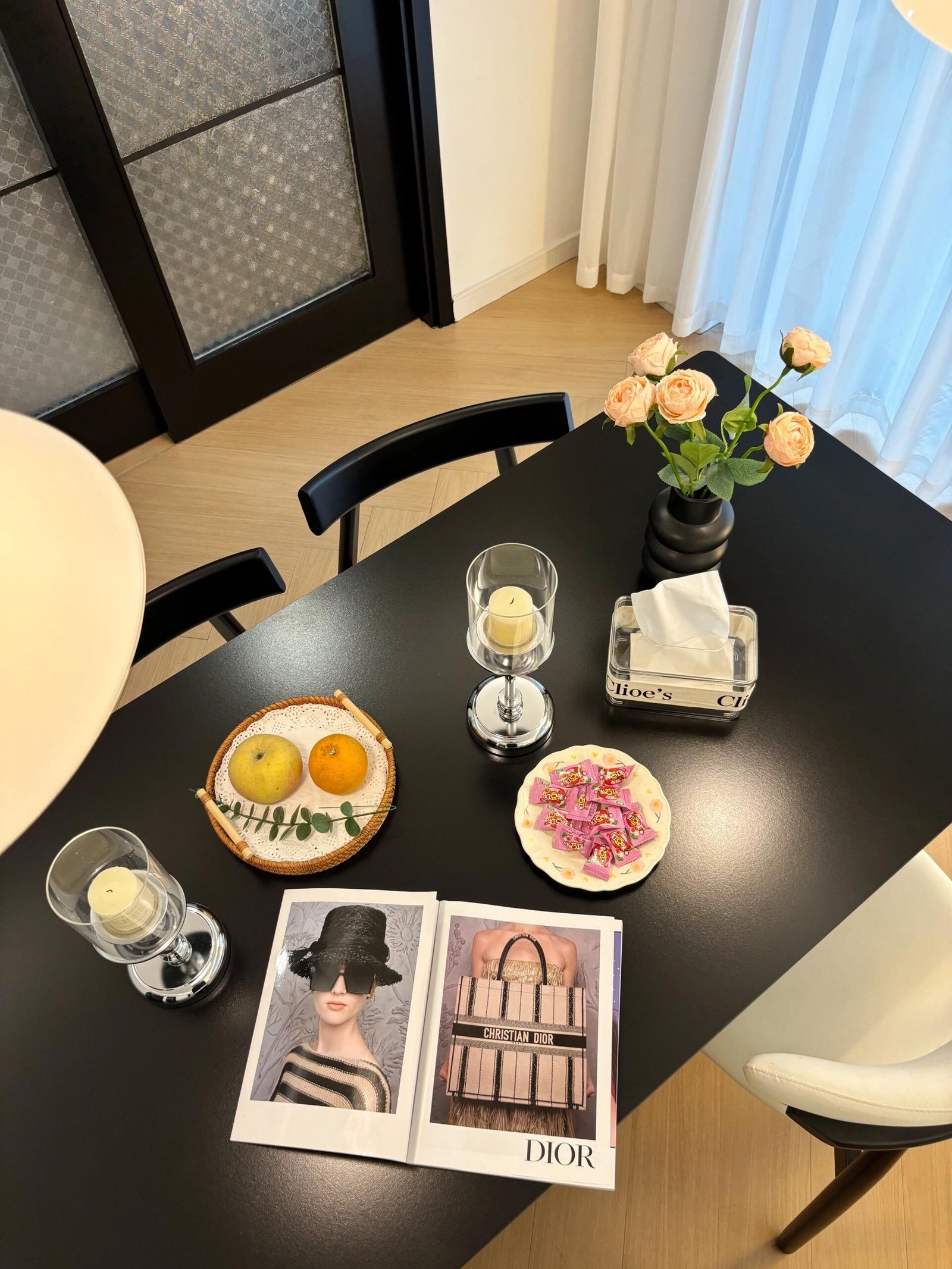 Neutral interior featuring a round dining table and minimalist decorative accents
