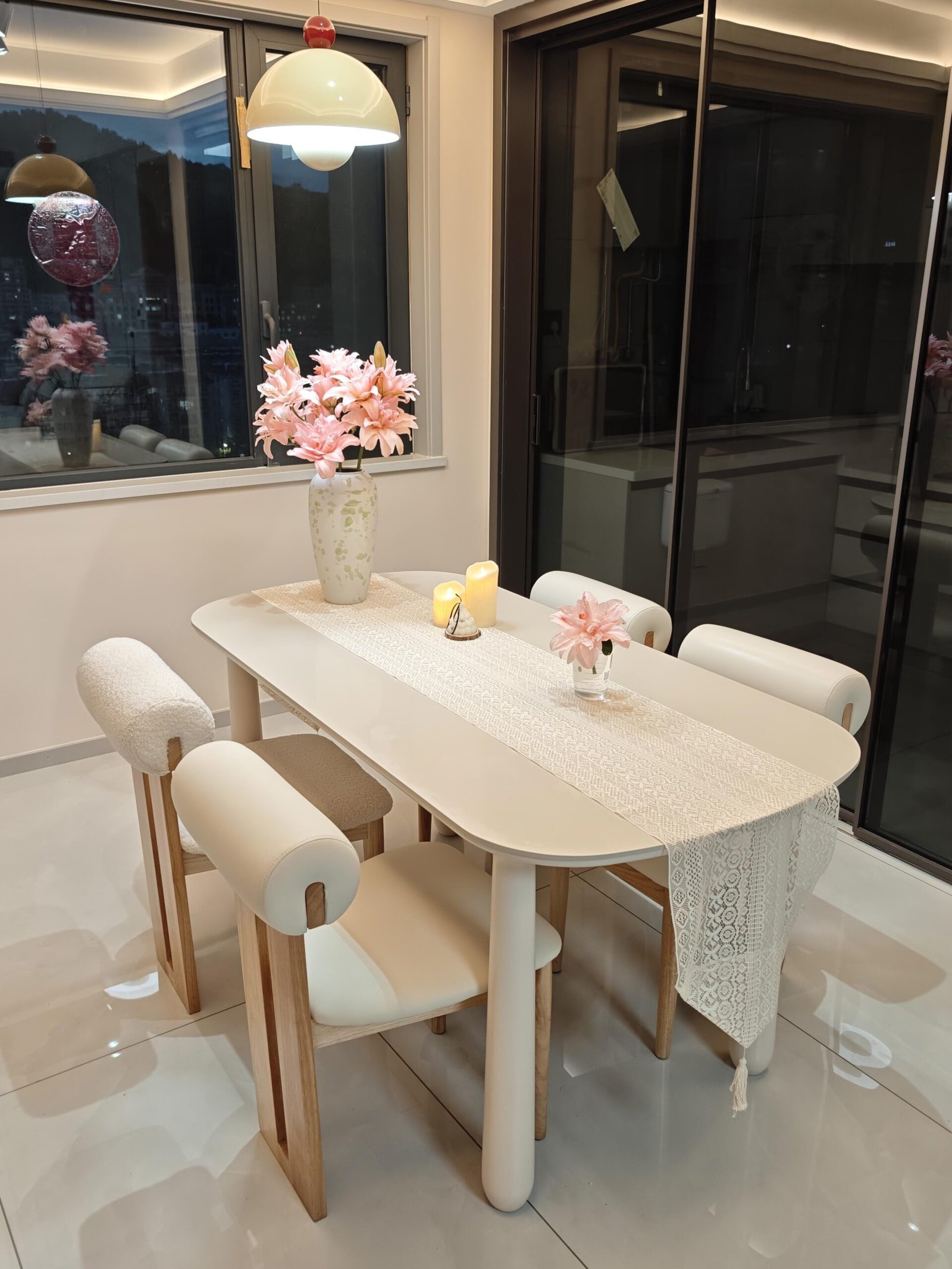 Elegant modern dining space with layered lighting and soft natural textures