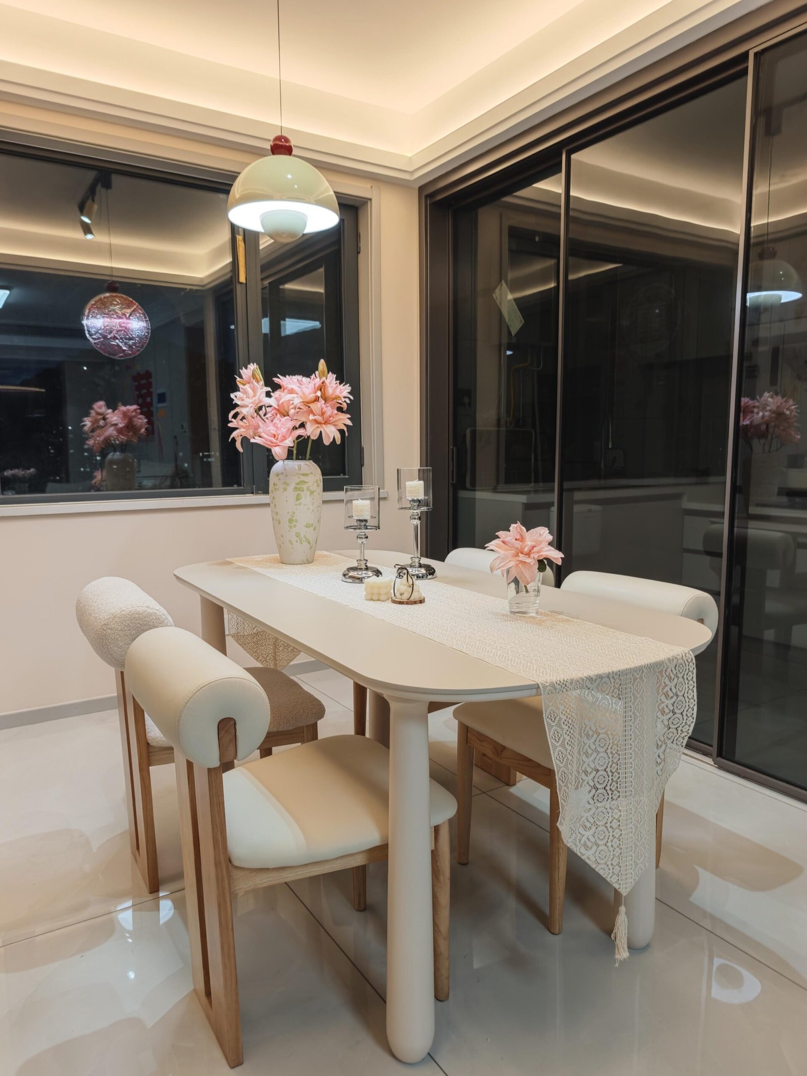 Modern Dining Table for 4 surrounded by plush chairs and a marble feature wall