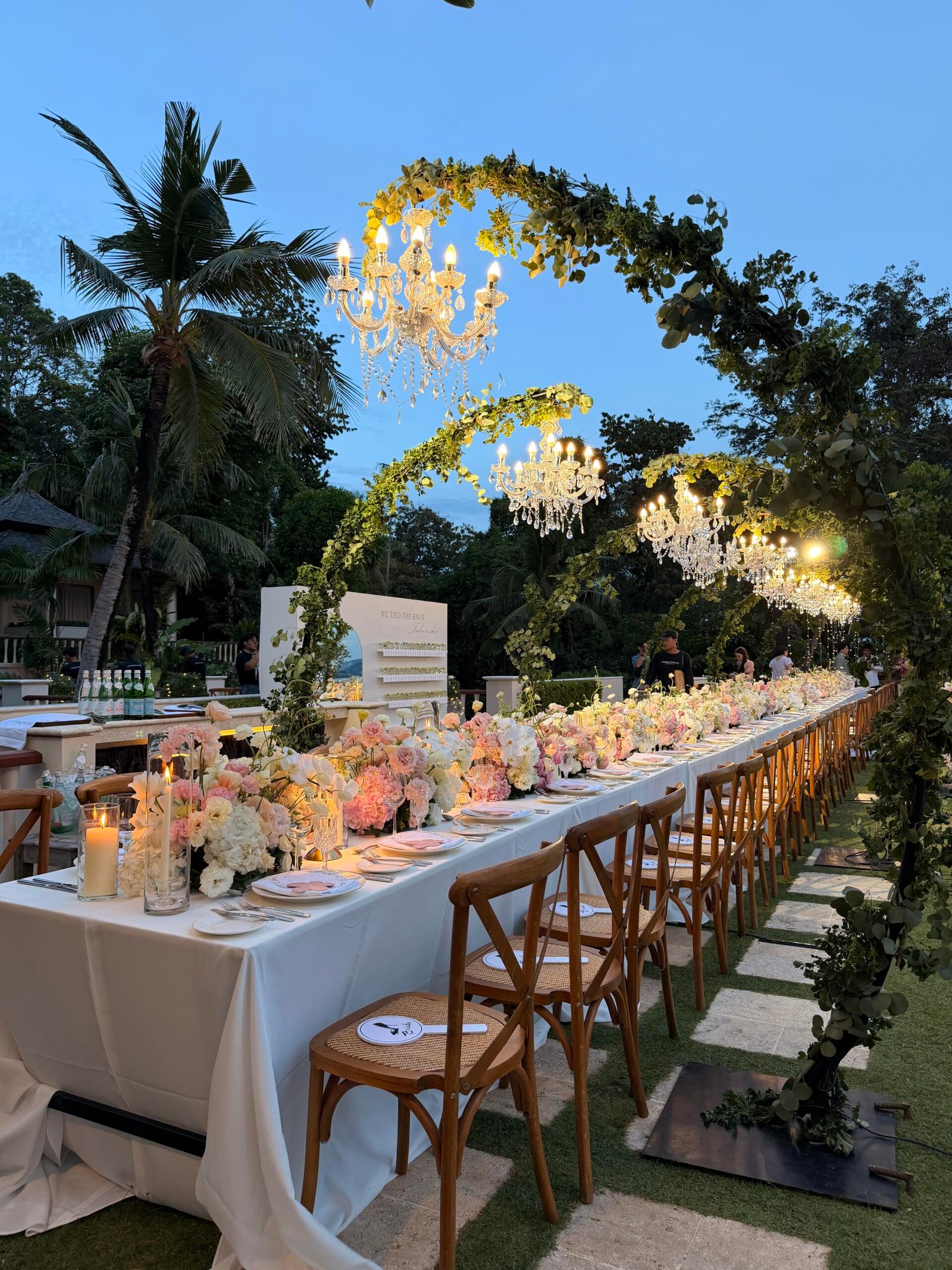Wedding reception tablescape with ivory linens and garden rose centerpieces