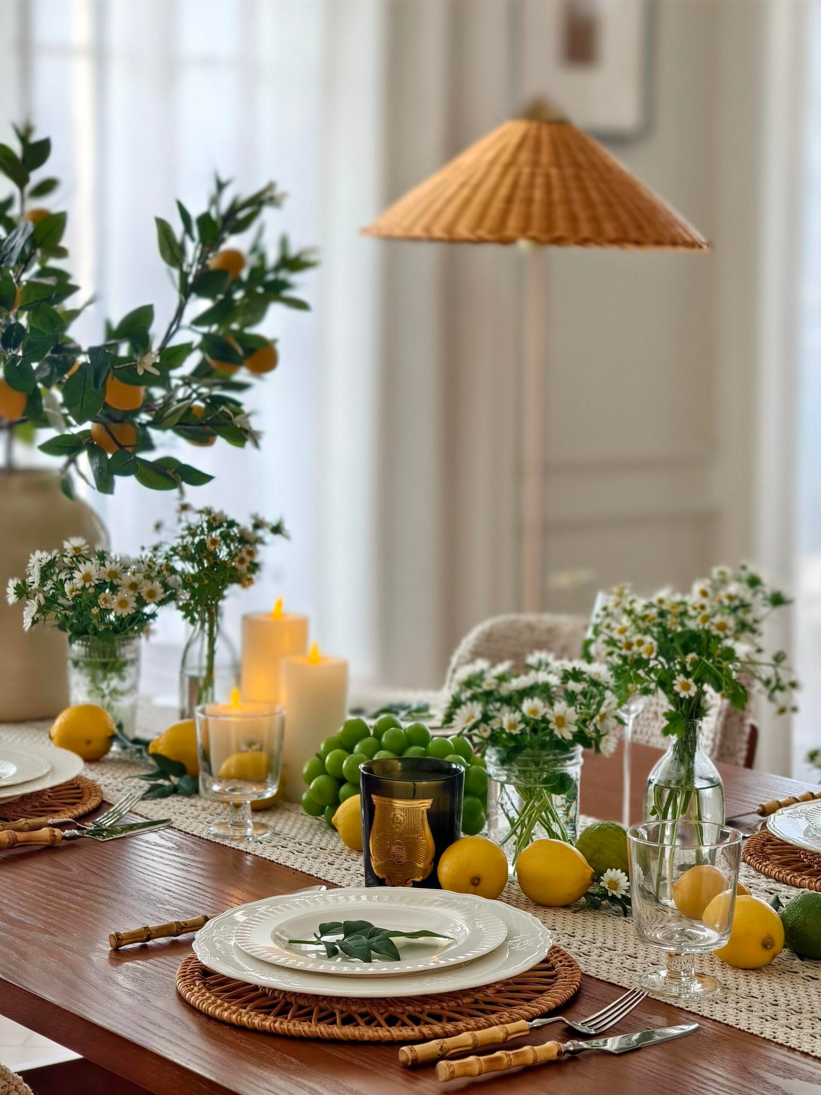 Dining table decor ideas featuring rattan chargers and bamboo-handled flatware place setting
